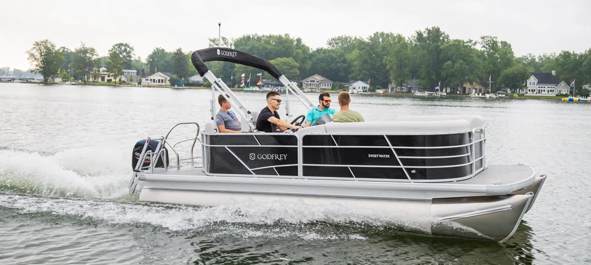 side view of a godfrey xperience cruise pontoon on a lake
