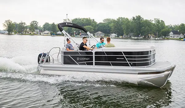 side view of a godfrey xperience cruise pontoon on a lake