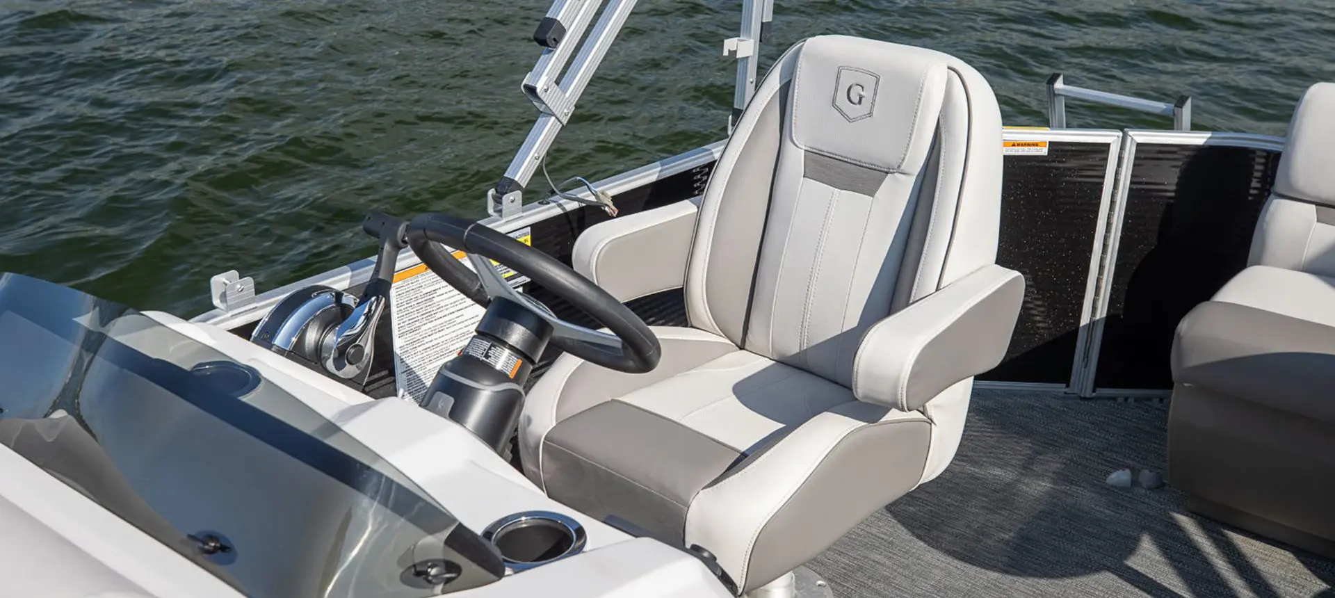 captain's chair and helm on a godfrey xperience cruise pontoon