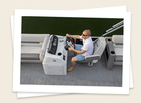 man sitting in the captain's chair on a godfrey Sweetwater Xperience split bench pontoon