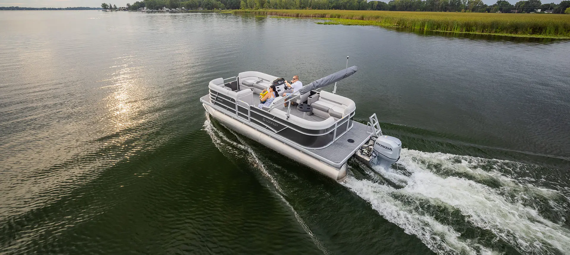 godfrey xperience split bench pontoon cruising on a lake