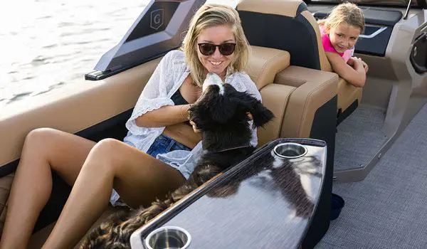 woman playing with a dog on a godfrey aquapatio pontoon