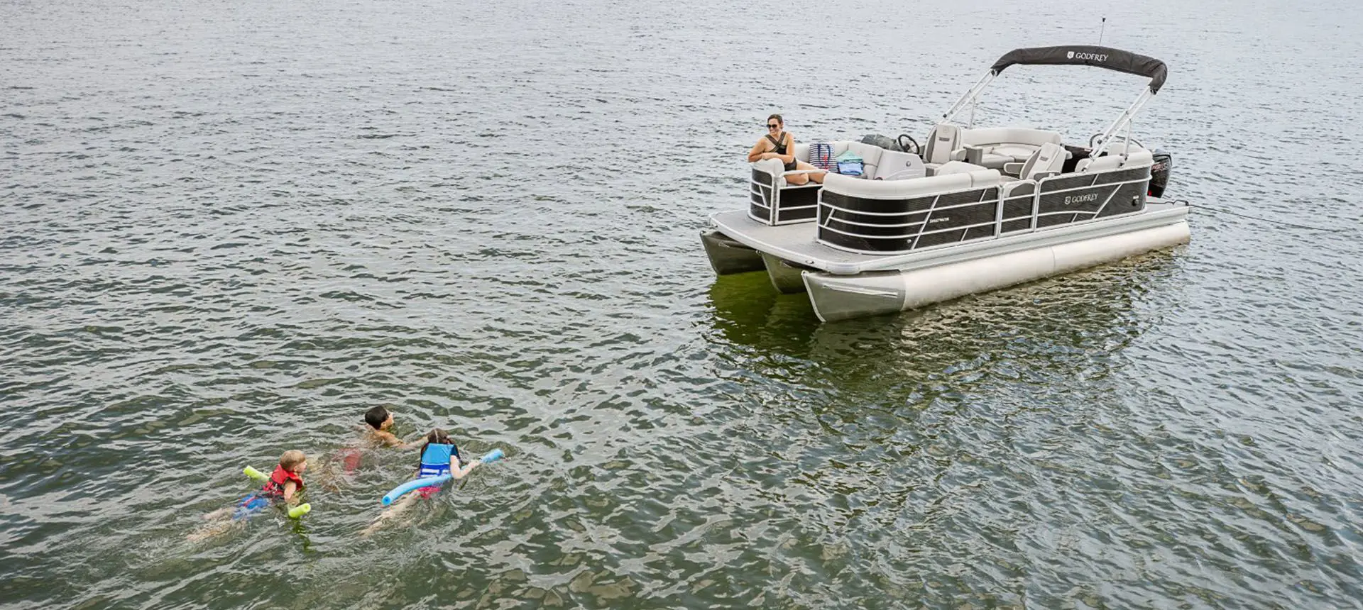 kids swimming by their godfrey xperience split bench pontoon