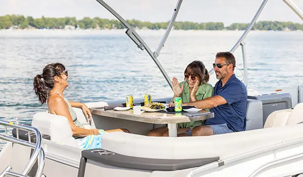family snacking at the stern table on a godfrey aquapatio entertainment pontoon