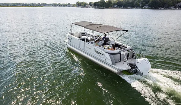 rear view of a godfrey aquapatio entertainment pontoon on a lake with the canopy up