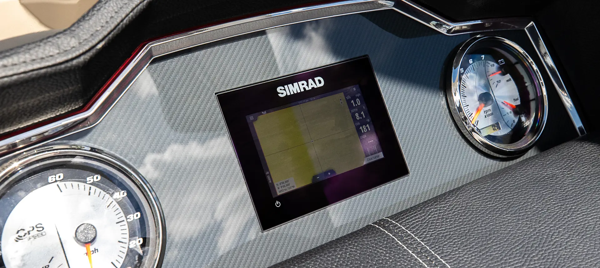 Simrad GPS at the helm on a Godfrey AquaPatio Lounge pontoon boat.