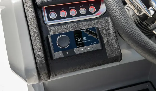 fusion audio controls at the helm on a godfrey aquapatio lounge pontoon