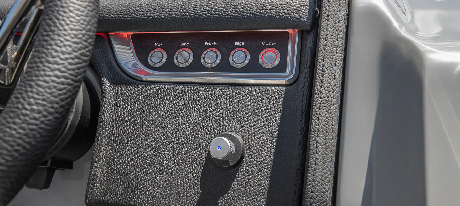 Switches at the helm on a Godfrey AquaPatio Lounge pontoon boat.