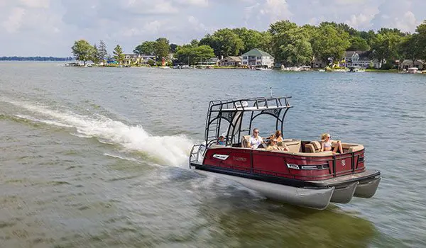 godfrey aquapatio sundeck pontoon cruising across a lake