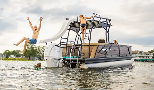 man going down the slide on a godfrey aquapatio sundeck pontoon