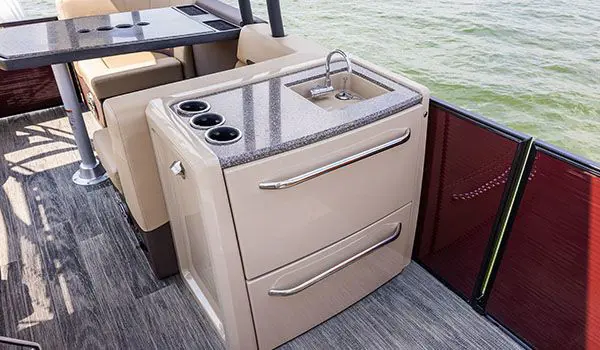 entertainment center with sink and integrated storage on a godfrey aquapatio sundeck pontoon