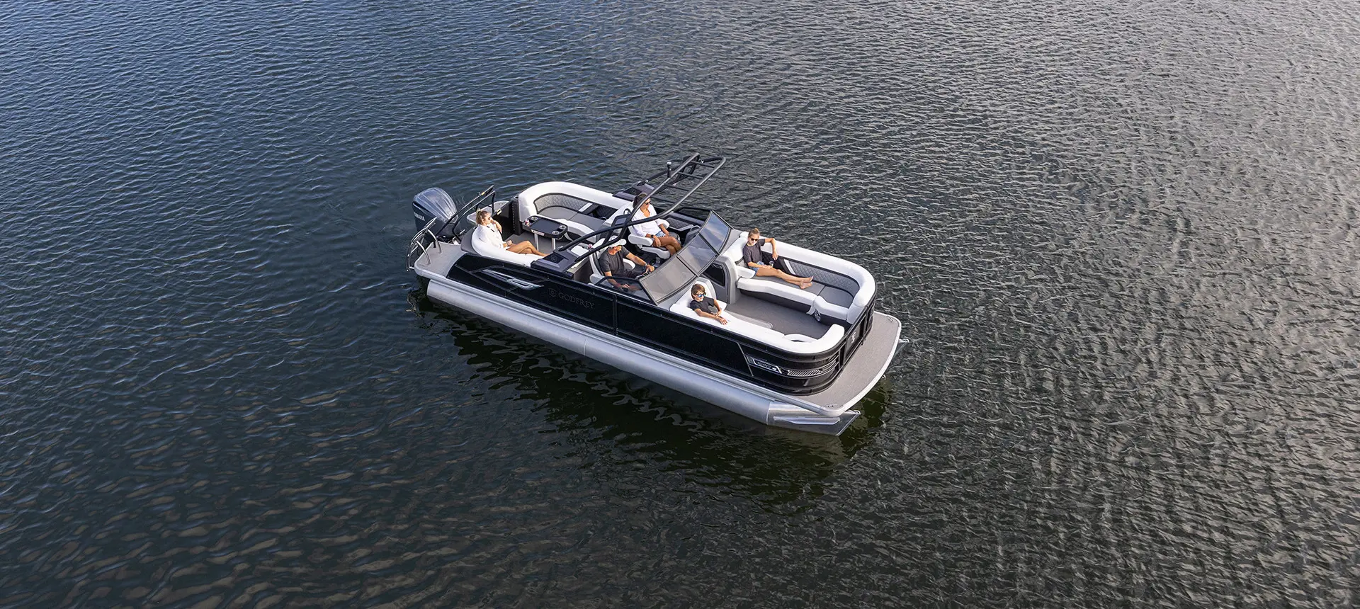 aerial view of a godfrey aquapatio winshield pontoon floating on a lake