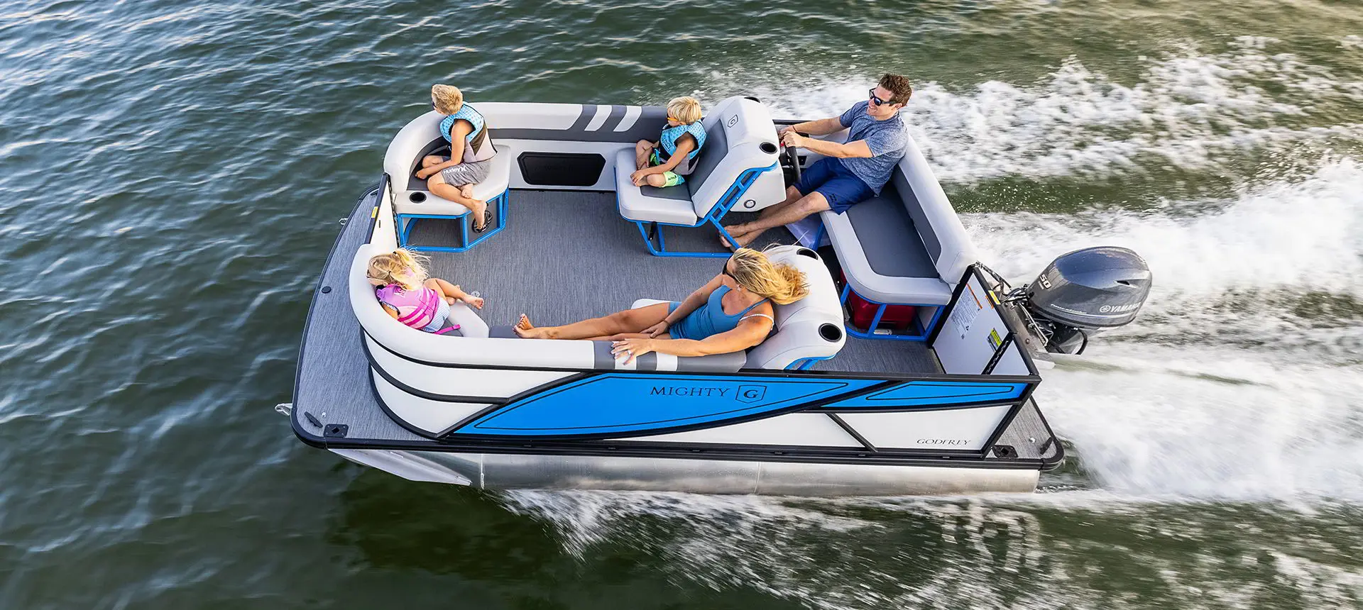 Aerial view of a Godfrey Mighty G Cruise pontoon boat on a lake.