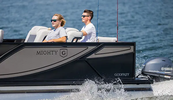 2 guys relaxing on a Godfrey Mighty G Fishing pontoon boat.