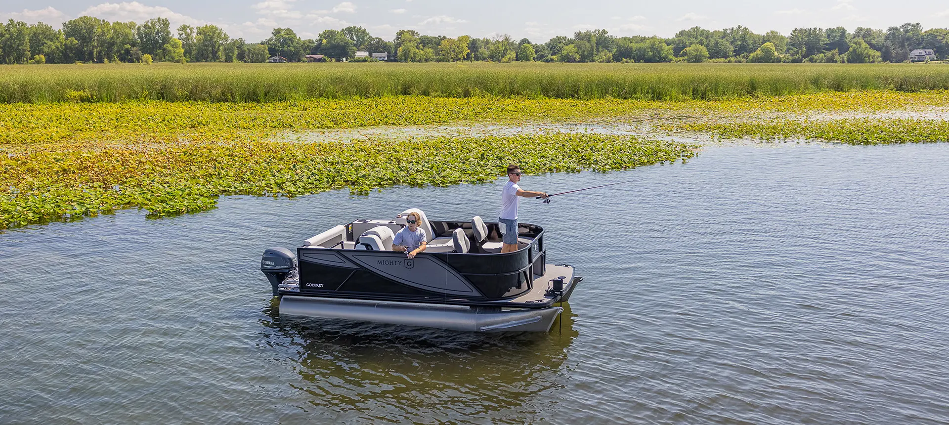 Guys fishing off the bow and side of a Godfrey Mighty G Fishing pontoon boat.