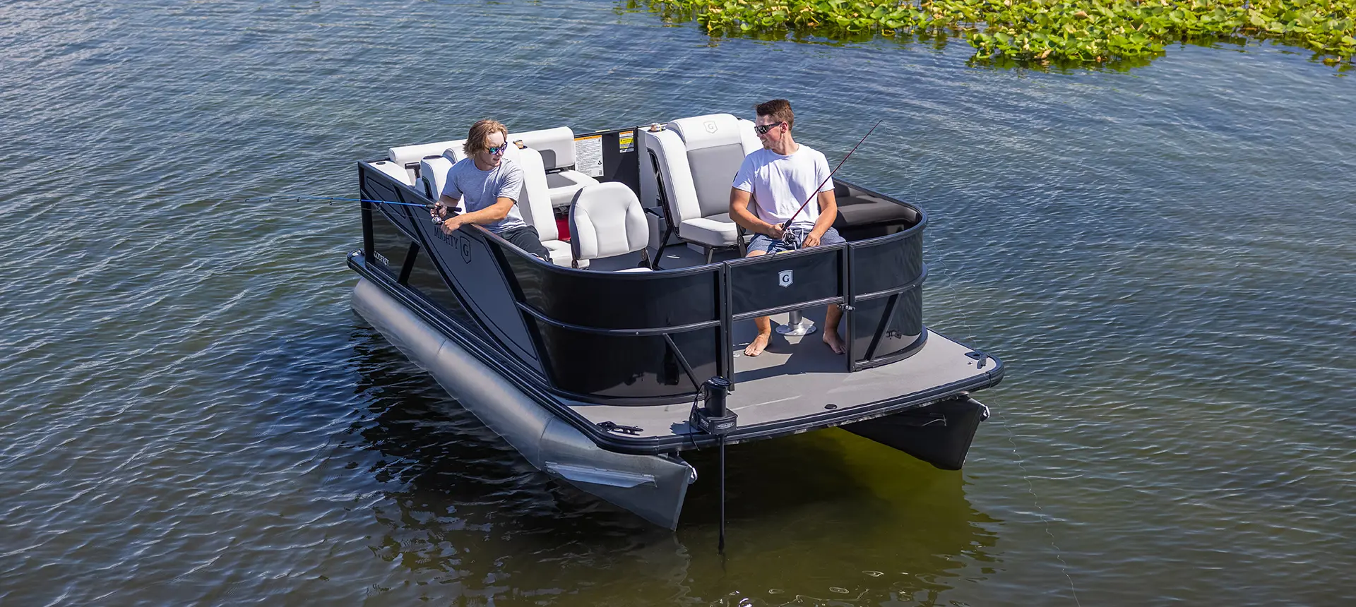 2 men fishing off the bow of a Godfrey Mighty G Fishing pontoon boat.
