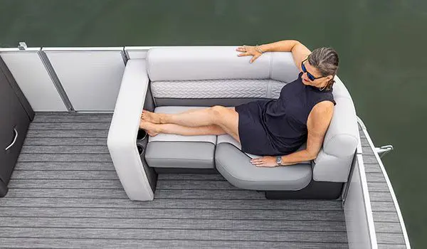 woman relaxing on the bow bench seat on a godfrey monaco cruise pontoon