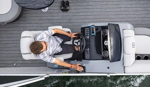 aerial view of a man sitting at the helm on a godfrey monaco cruise pontoon