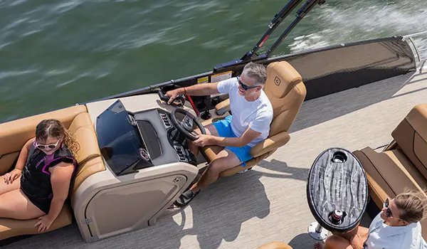aerial view of a man at the helm on a godfrey monaco lounge pontoon