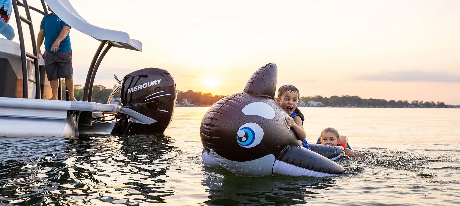 kids swimming near the stern of a godfrey monaco sundeck pontoon