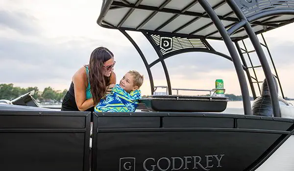 mother and son on a godfrey monaco sundeck pontoon
