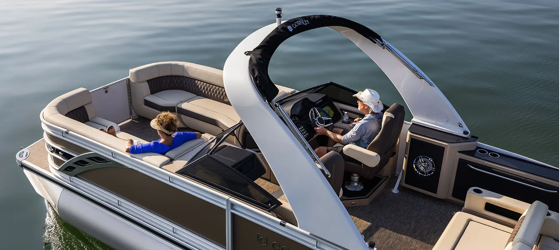 aerial view of a man and woman relaxing on a godfrey sanpan lounge pontoon