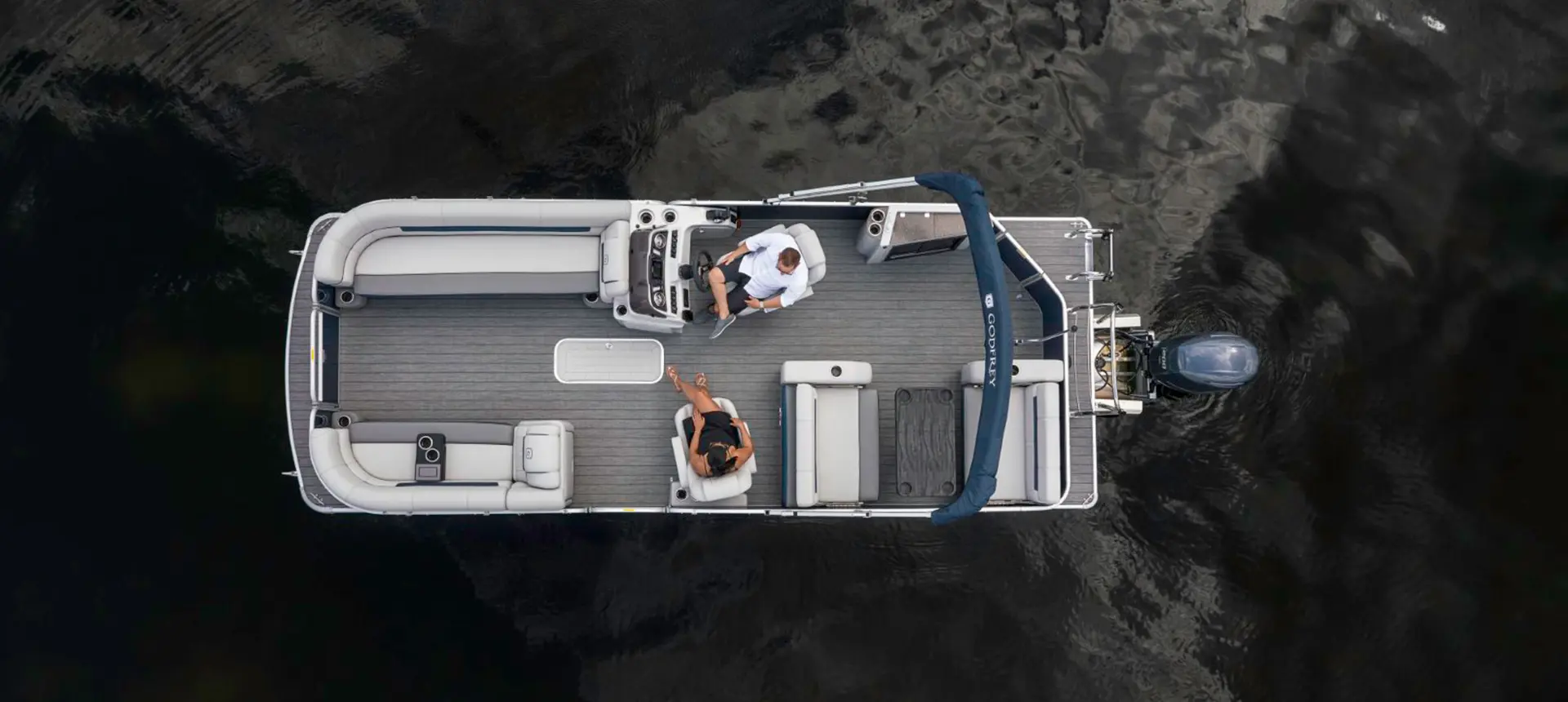 aerial view of a couple relaxing on a godfrey sweetwater entertainment pontoon