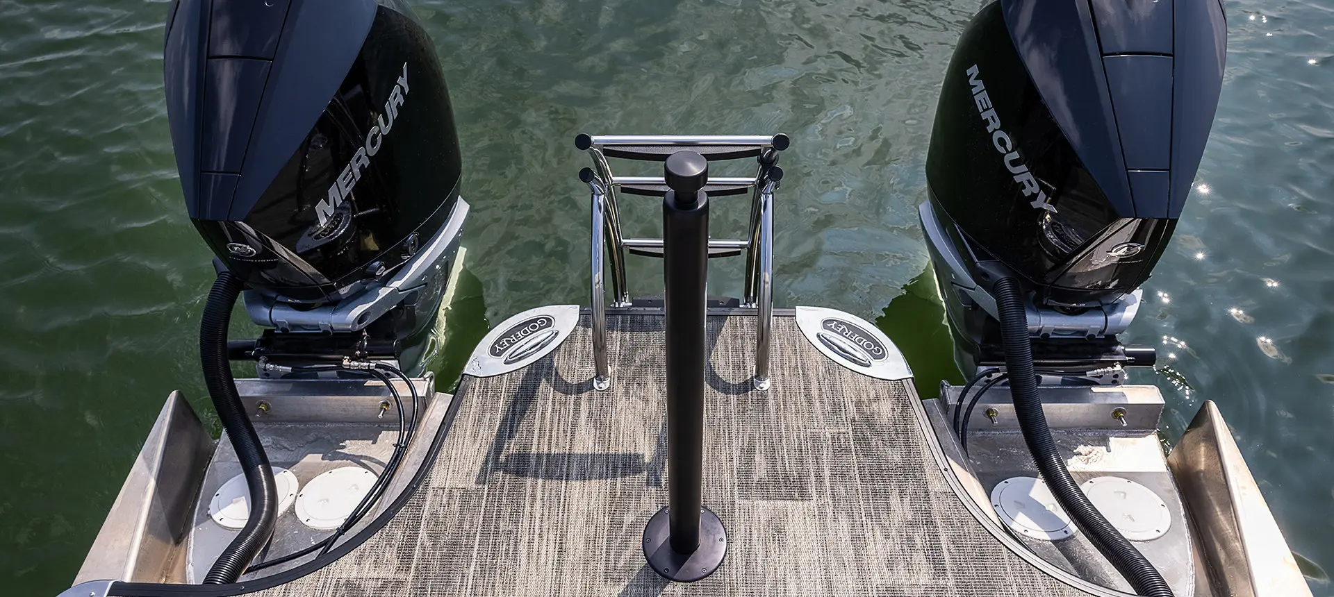 Pylône de traction de skieur, échelle arrière et deux moteurs sur un bateau ponton Godfrey Sanpan Lounge 2700 ULW Twin.