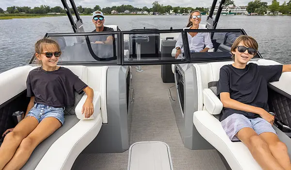kids and parents relaxing on a godfrey aquapatio series pontoon