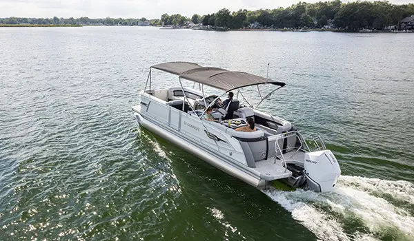 godfrey aquapatio series pontoon with canopy up cruising on a lake