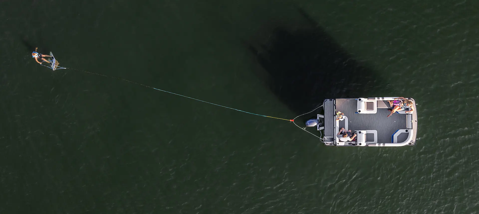 aerial view of a family cruising the lake on a godfrey mighty g cruise pontoon