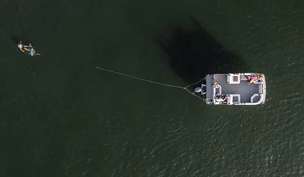 aerial view of a family cruising the lake on a godfrey mighty g cruise pontoon