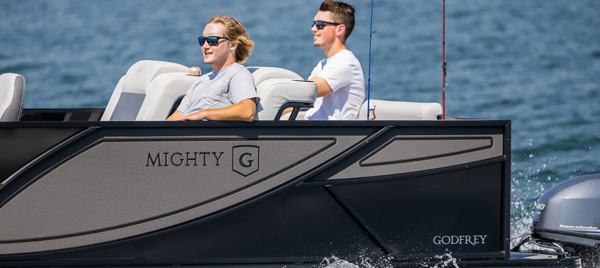2 young men cruising out to a fishing sport on a godfrey mighty g fishing pontoon