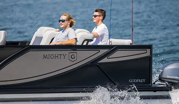 2 young men cruising out to a fishing sport on a godfrey mighty g fishing pontoon