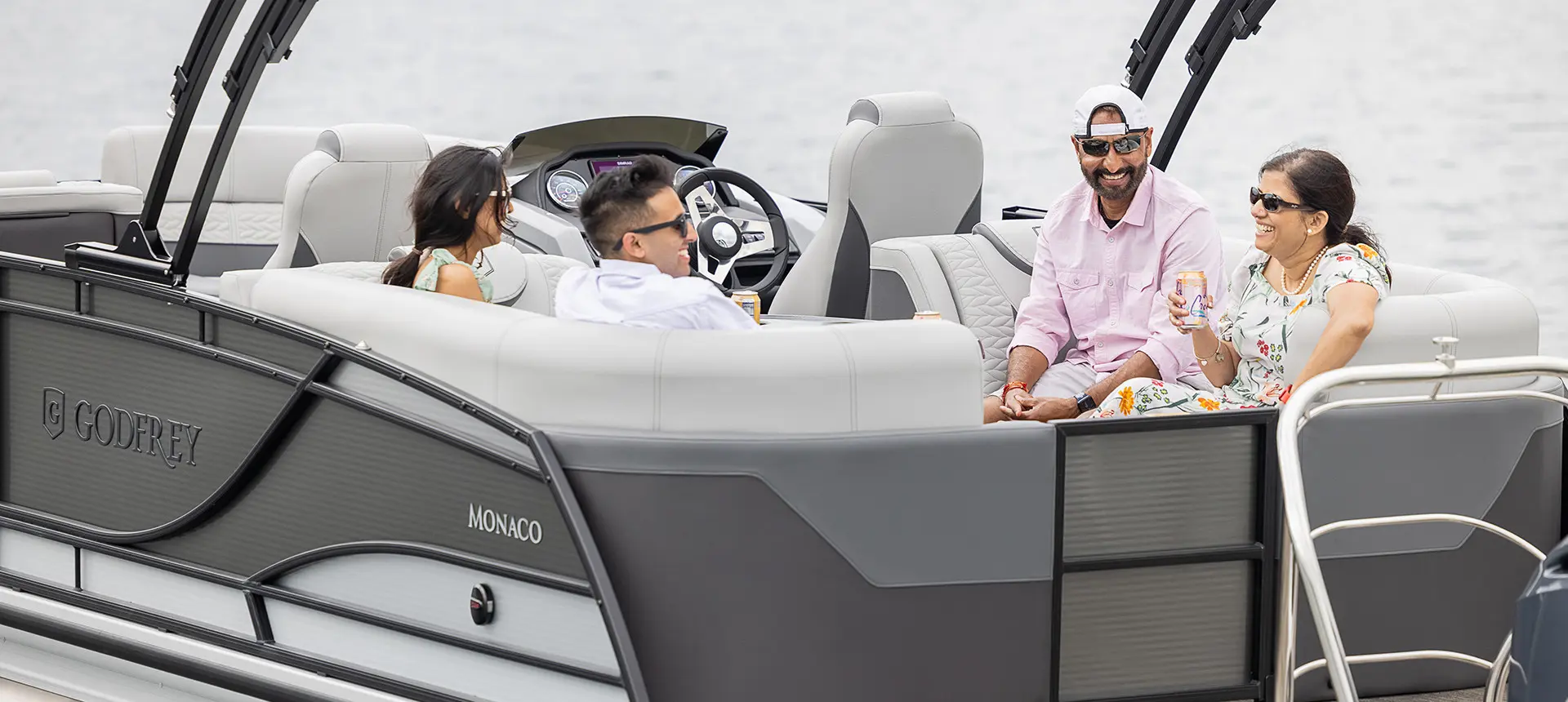 friends relaxing on the stern split bench seats on a godfrey monaco series pontoon
