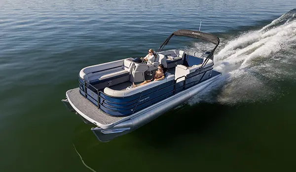 2 women cruising on a lake in a godfrey sweetwater tritoon