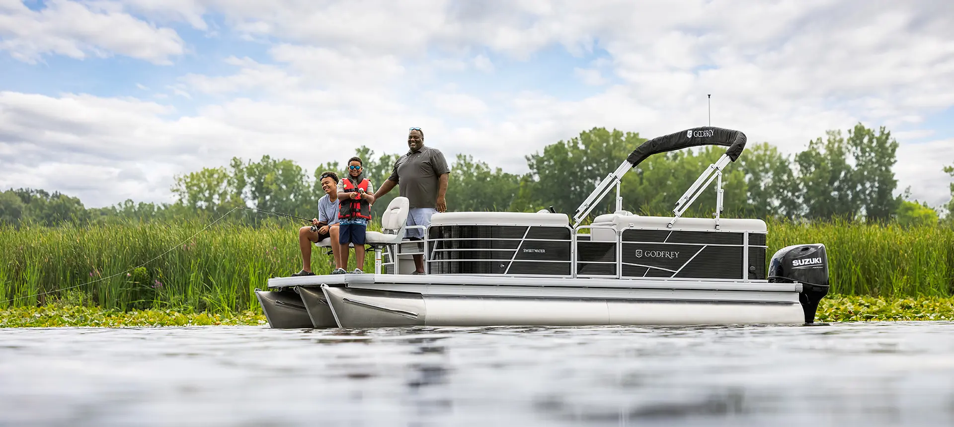 family fishing off the bow of a godfrey xperience fishing pontoon