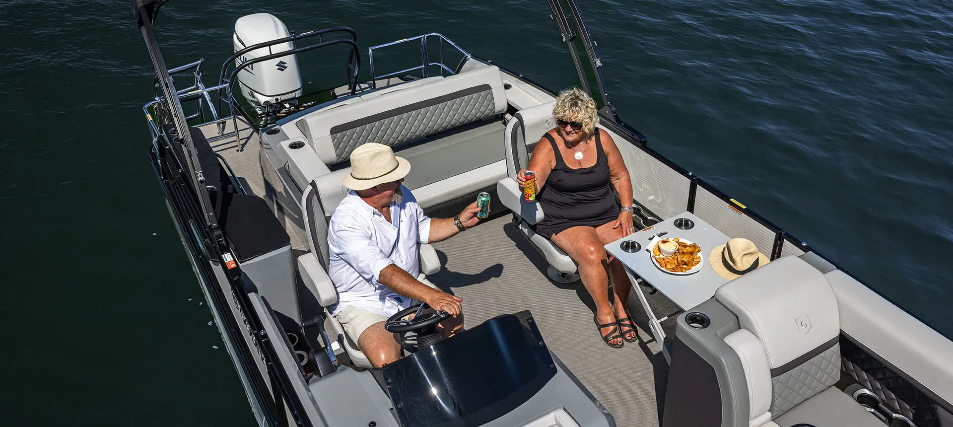 godfrey aquapatio sundeck pontoon cruising across a lake