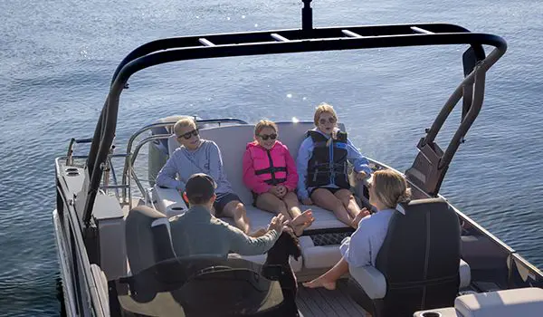 5 people relaxing on the stern seating options on a godfrey sanpan lounge pontoon