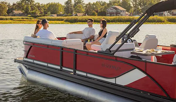 2 couples relaixing on the bow split bench seating on a godfrey sweetwater entertainment pontoon