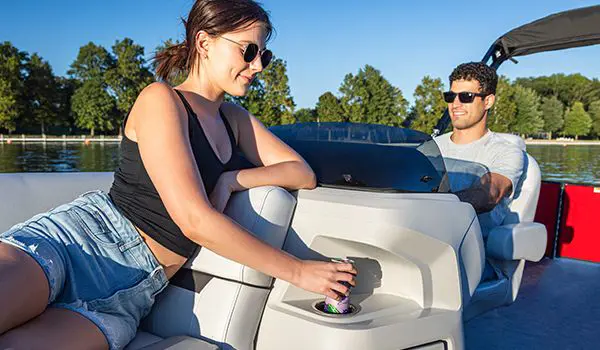 woman using the cupholder on a godfrey sweetwater entertainment pontoon