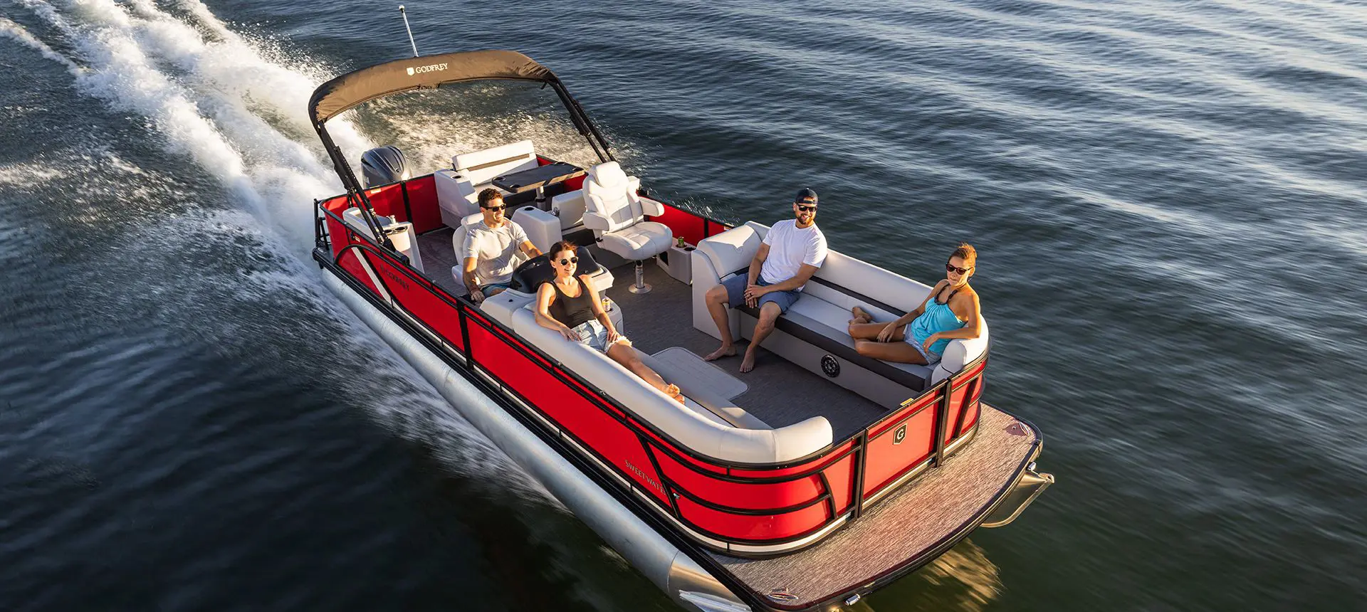aerial view of 4 people enjoying the lake on a godfrey sweetwater entertainment pontoon