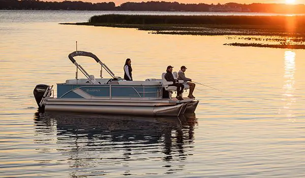 people fishing at dusk on a godfrey sweetwater fishing pontoon