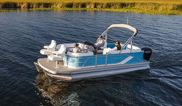 3 people on a godfrey sweetwater fishing pontoon cruising to their spot