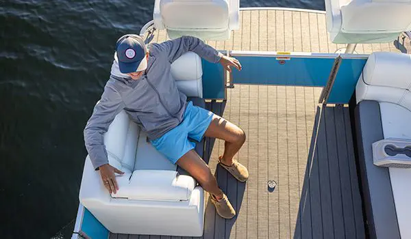 man sitting on a godfrey sweetwater fishing pontoon