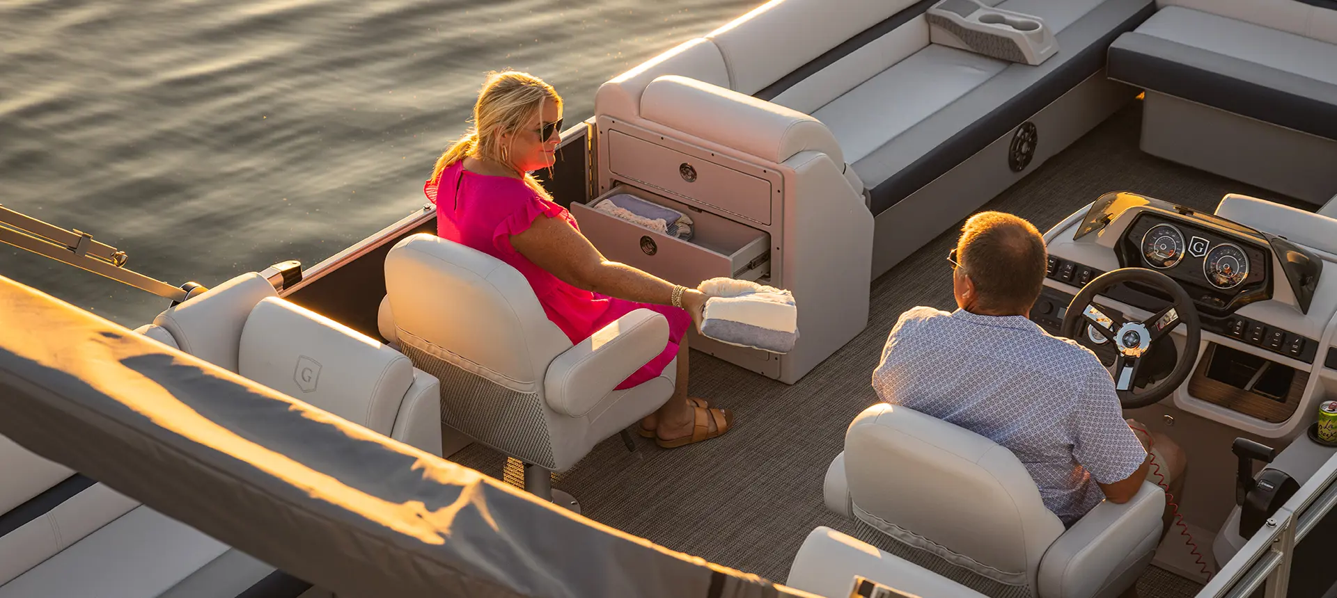 woman sitting in the co-captain's chair on a godfrey sweetwater split bench pontoon