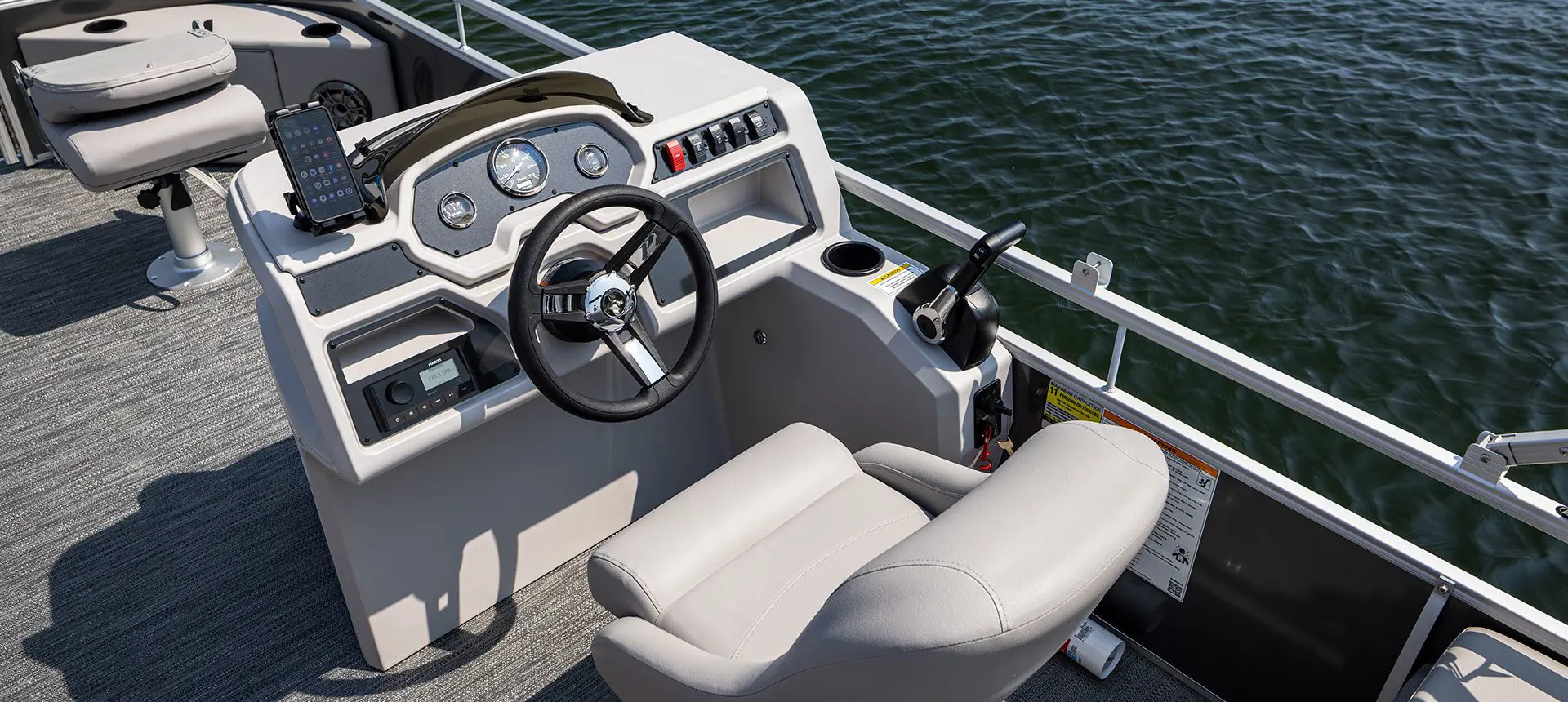 captain's chair and steering console on a godfrey xperience fishing pontoon