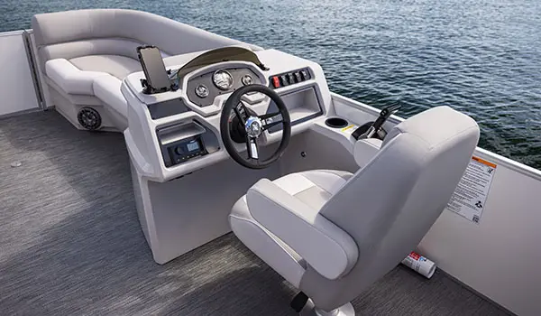 captain's chair and steering console on a godfrey xperience split bench pontoon
