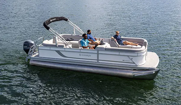 side view of a godfrey xperience split bench pontoon floating on a lake