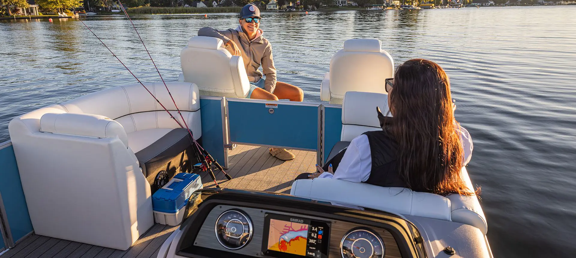 2 women cruising on a lake in a godfrey sweetwater tritoon
